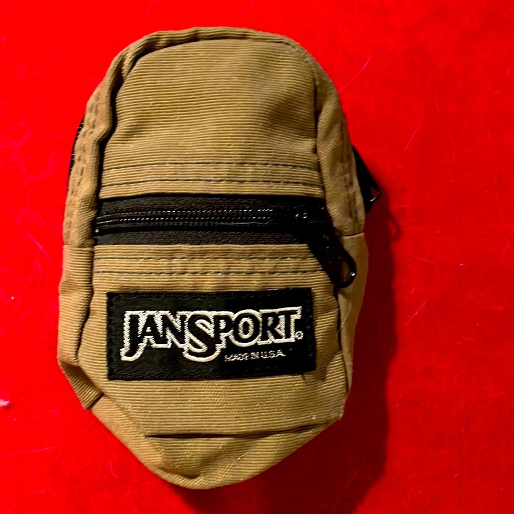 JanSport mini knapsack in khaki green. Perfect for dolls or used on your wrist.